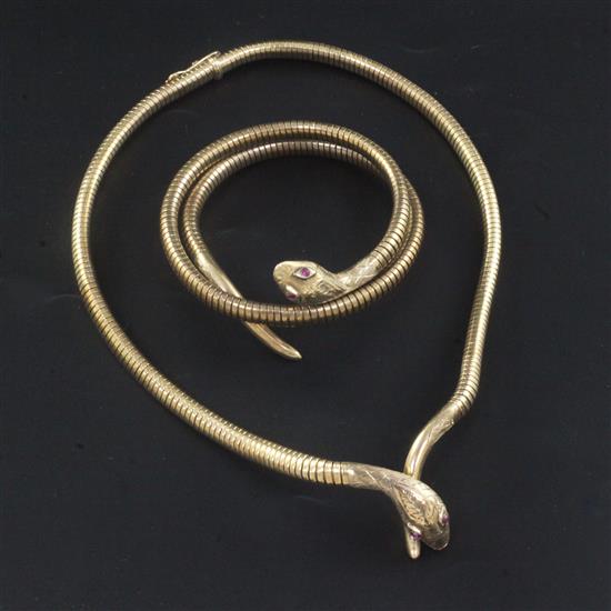 A 1980s 9ct gold and gem set coiled snake bracelet and similar necklace, gross 60 grams.